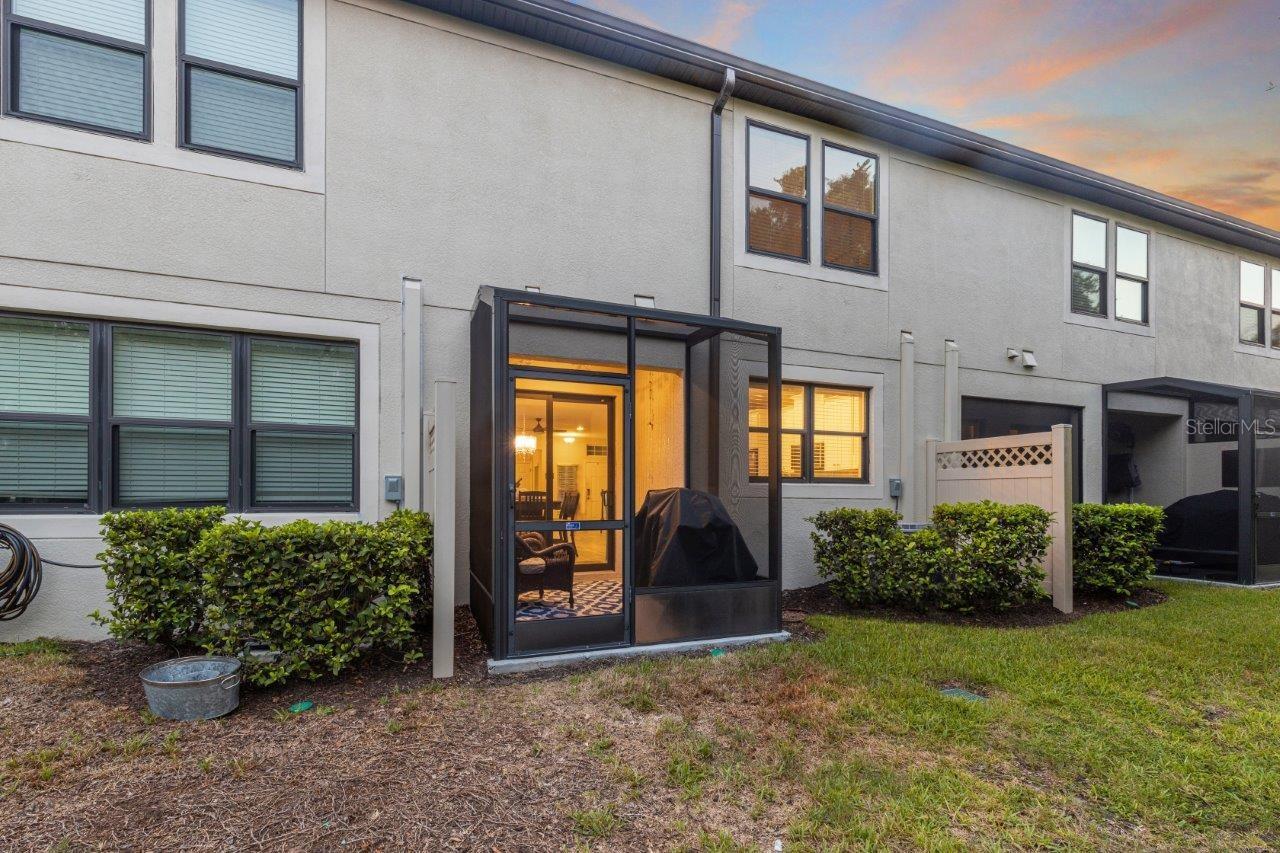 Rear elevation featuring the screened-in lanai and impact windows.