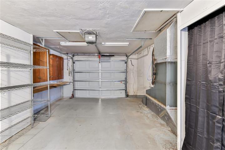 OVERSIZE GARAGE WITH LOTS OF STORAGE PLUS ATTIC. NEWER ALUMINUM GARAGE DOOR WITH OPENER.