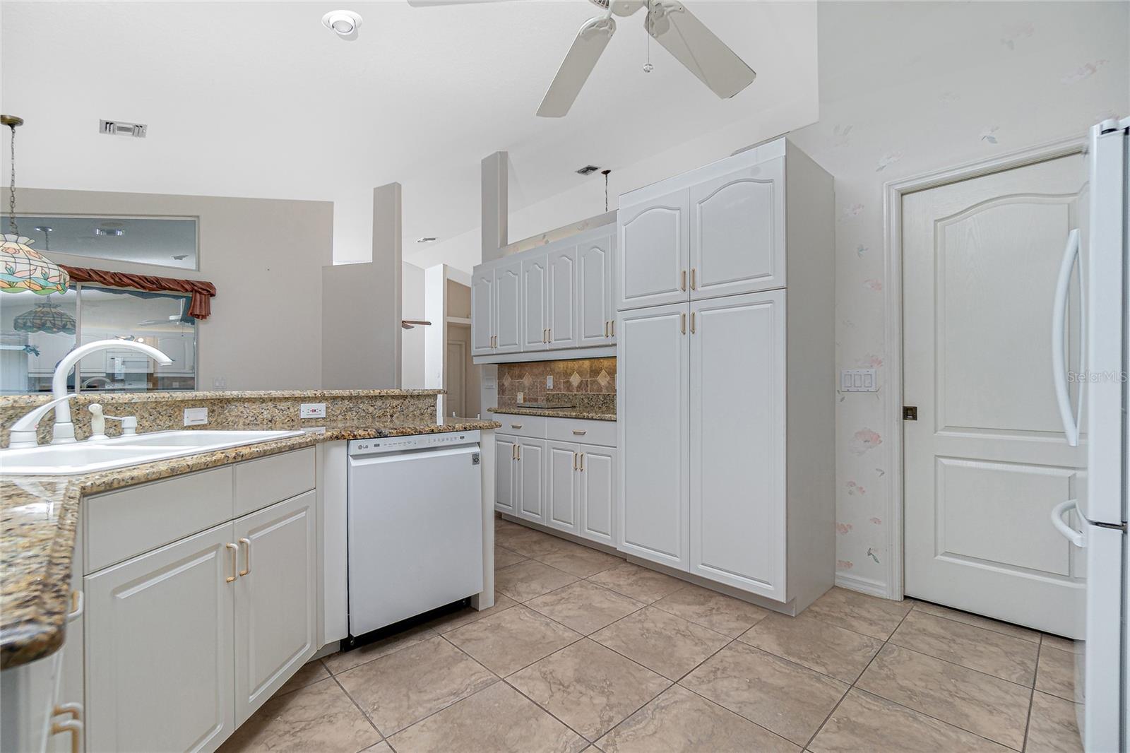 Some additional kitchen features are the double sink, spacious panty and pocket door to the laundry room.