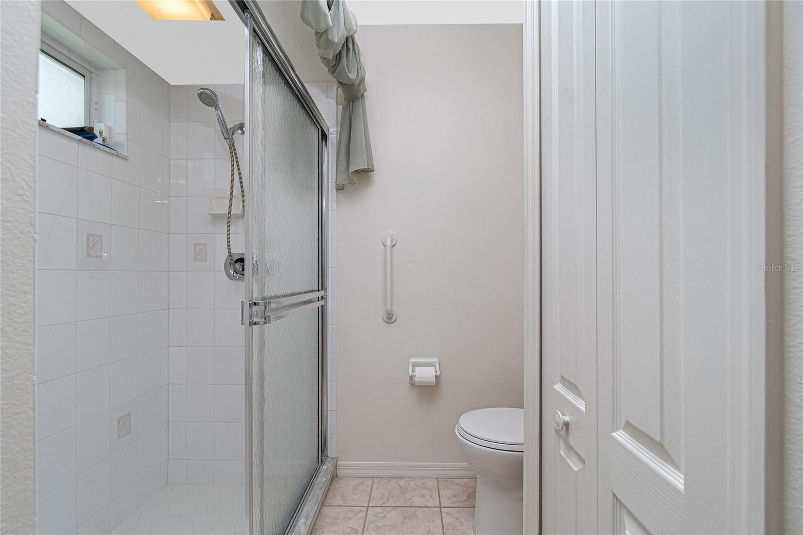 Bathroom #2 has a step-in shower with doors