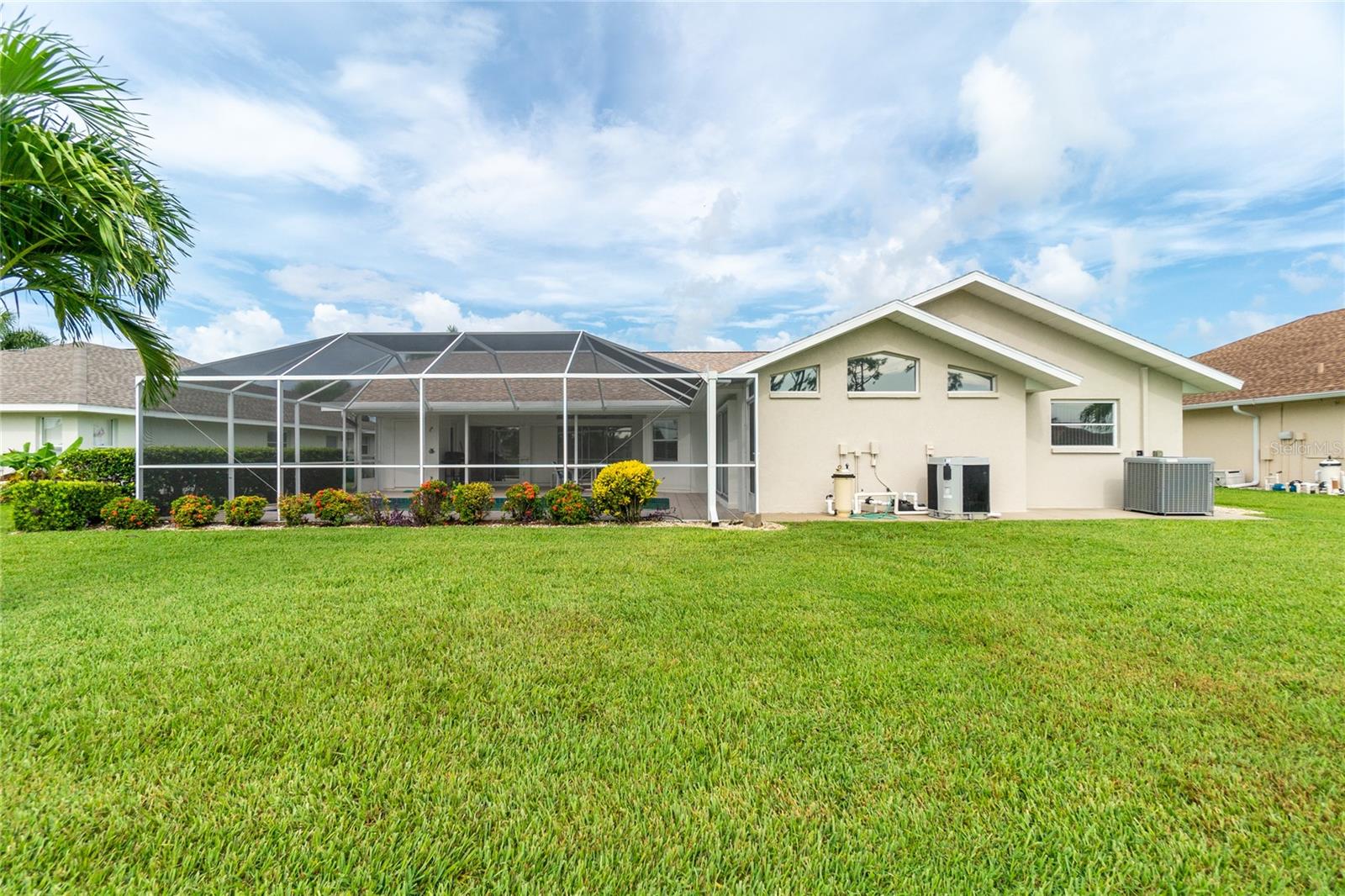 This is the rear view of the home and pool area.