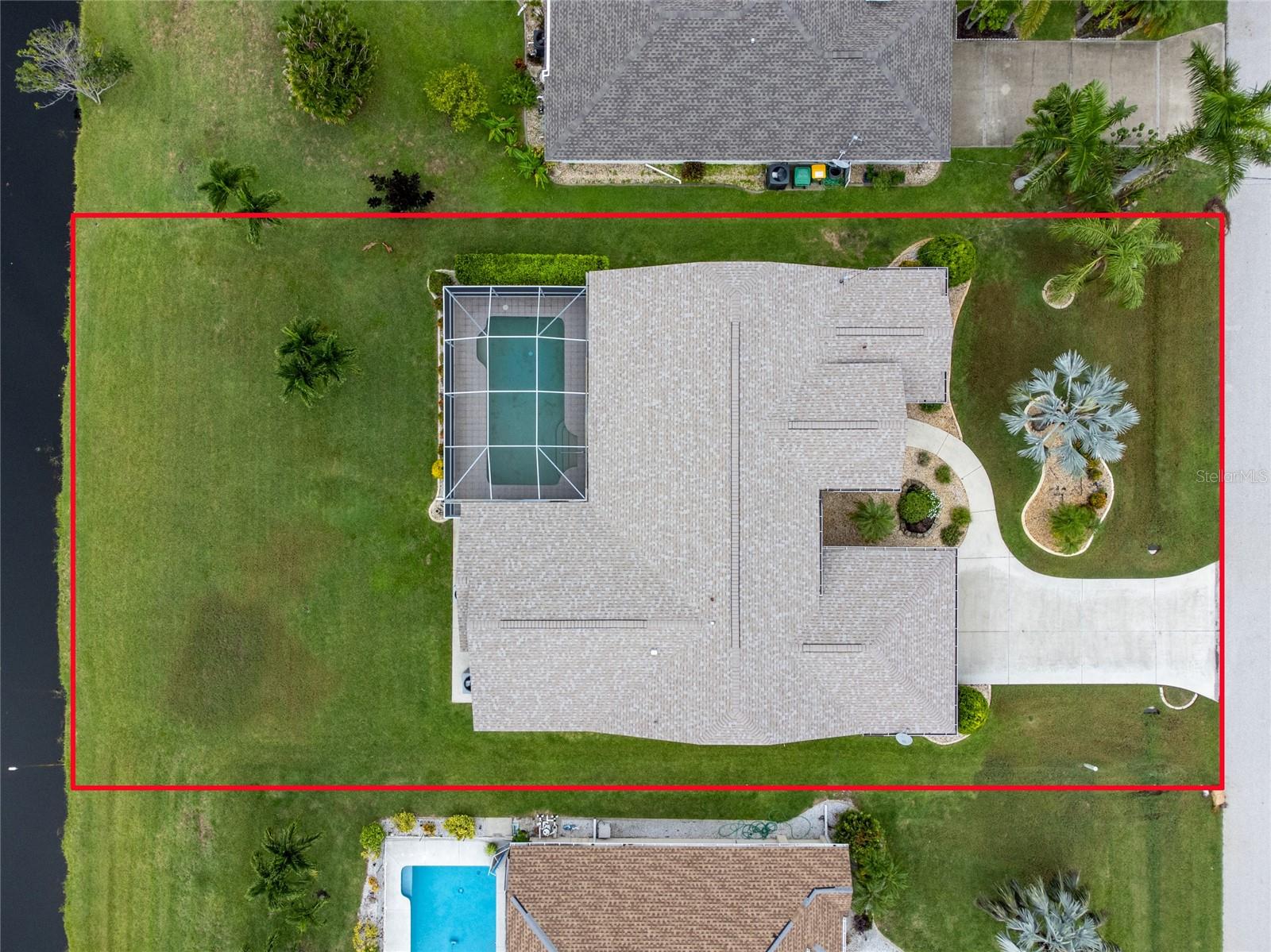 An overview of the lot and home along the canal.