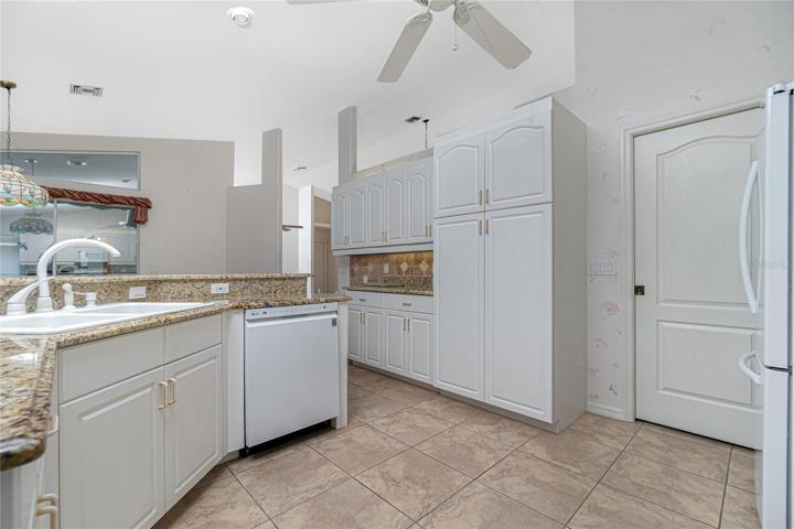 Some additional kitchen features are the double sink, spacious panty and pocket door to the laundry room.