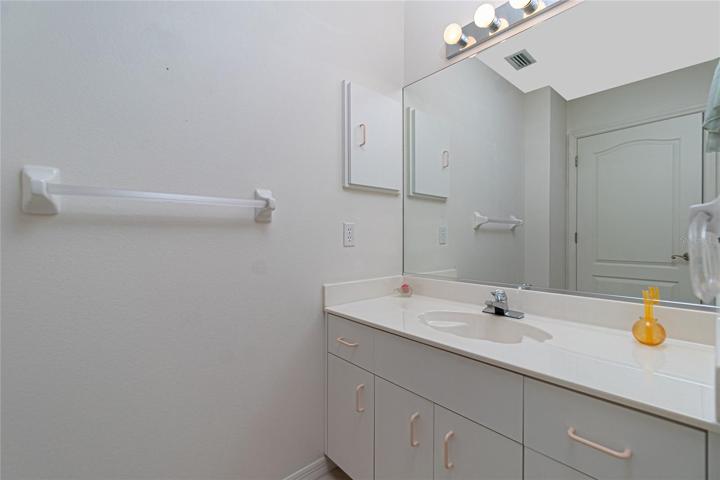 Bathroom #2 has a vanity/ cultured marble countertop and basin and linen closet.