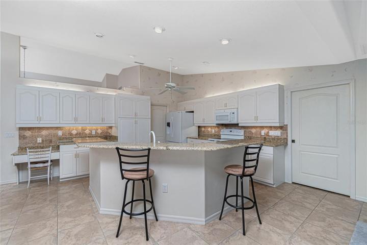 The kitchen is light and bright with cathedral ceiling, above cabinet and under cabinet lighting along with recessed lighting.