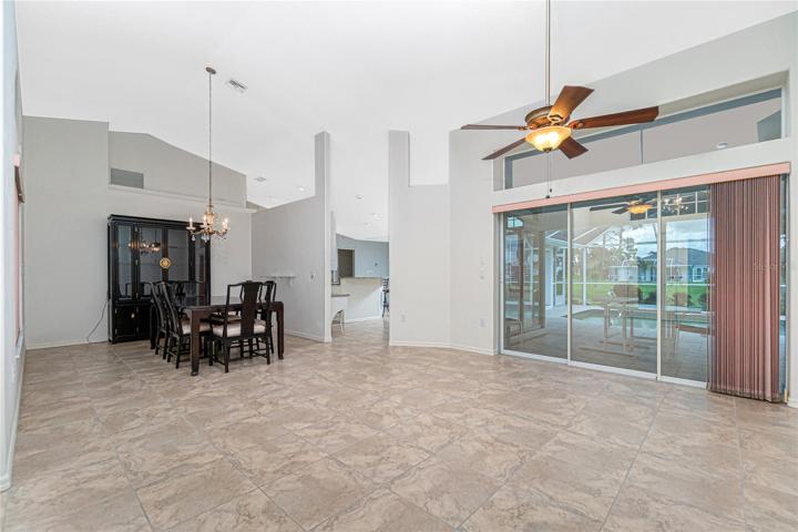 Soaring ceiling over the dining room and living room, which opens to the lanai and pool.