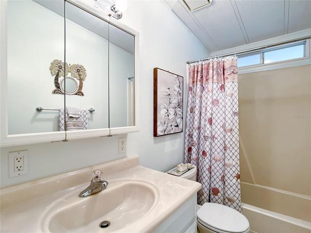 The guest bathroom has a shower in the tub