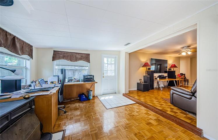 Office/den/sunroom with wood burning fireplace