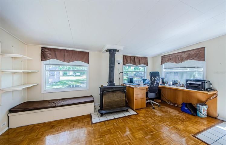 Office/den/sun room with wood burning fireplace