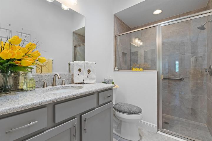 THE GUEST BATH HAS A BEAUTIFUL WALK-IN SHOWER