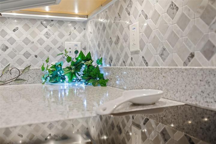 UNDER-COUNTER LIGHTS AND A GORGEOUS BACKSPLASH MAKE THIS KITCHEN STAND OUT!!!