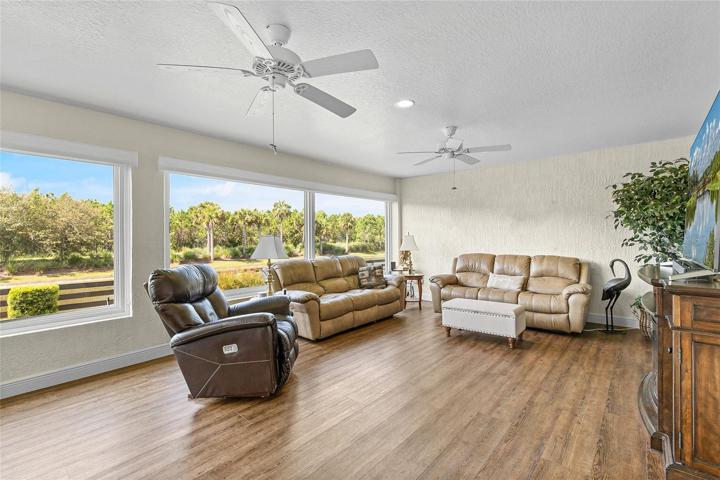 CHECK IT OUT! THIS ROOM SO LARGE IT HAS 5 CEILING FANS! BEAUTIFUL FLOORING THROUGHOUT AND CLIMATE-CONTROL AS WELL...