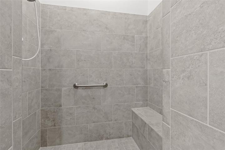 STUNNING TILED WALK-IN ROMAN SHOWER WITH A BUILT-IN BENCH