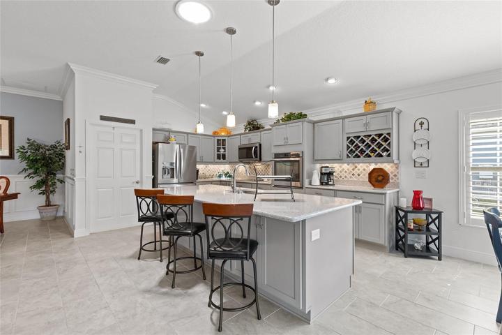 THE KITCHEN IS STUNNING... STAINLESS APPLIANCES, A WINE RACK, A BUILT-IN WALL OVEN, TONS OF CABINETS & COUNTER SPACE AND MORE...