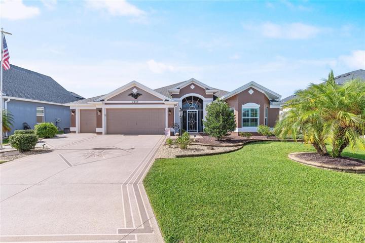 GREAT LOCATION AND CURB APPEAL! CHECK OUT THE PAINTED DRIVEWAY, MANICURED LANDSCAPING AND GOLF CART GARAGE