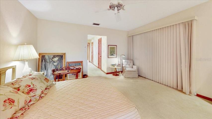 Primary bedroom. Hallway to bathroom.