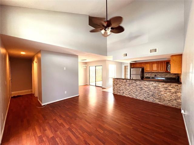 Living room, looking toward front door on the left and kitchen on the right