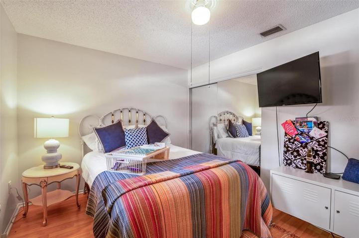 Your guest bedroom features a ceiling fan and a window