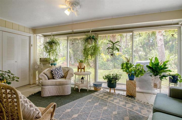 The glassed-in patio boasts a ceiling fan and the laundry room