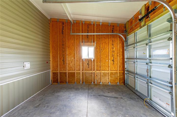 Gold cart garage with roll up door.
