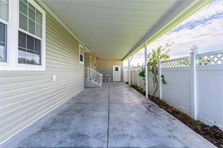 Carport has privacy fence installed.