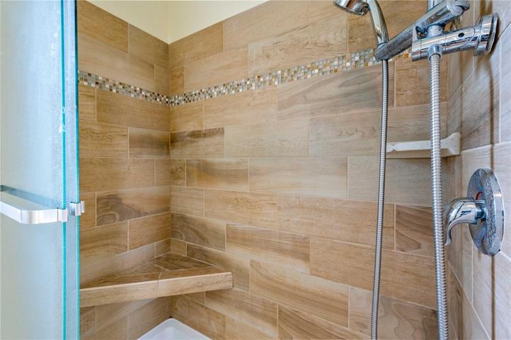 Custom tile step-in shower with bench.