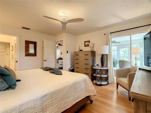 Primary Bedroom with a sliding door out to the Florida Room