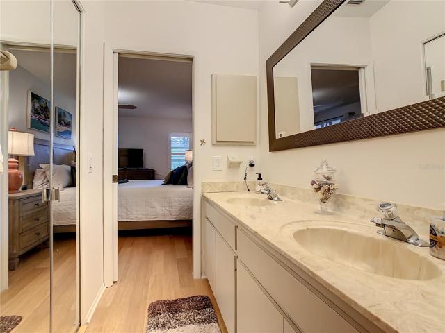 Primary Bathroom with dual sinks and walk in closet