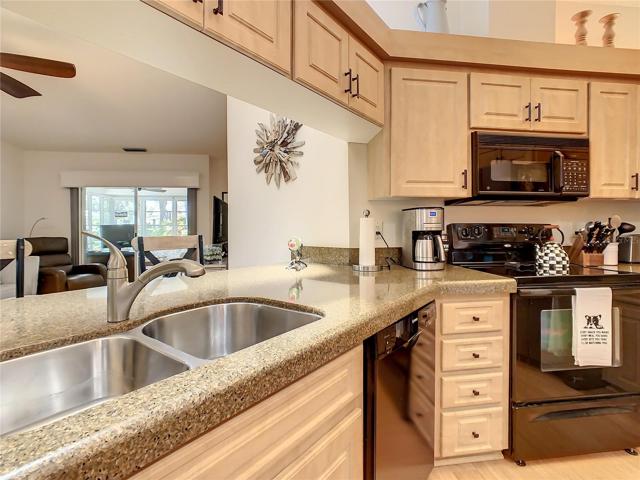 Kitchen looking out over the breakfast bar to the family room