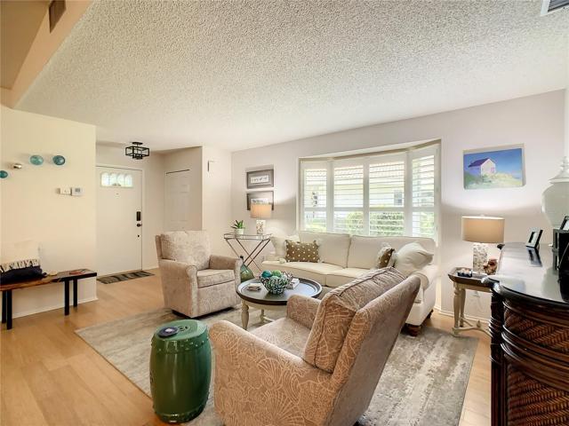 View of the living room area looking back towards the front door