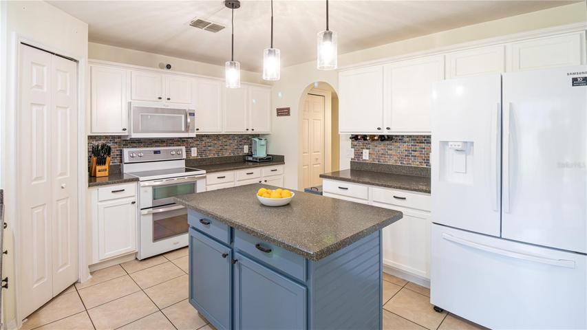 Bright kitchen with center island and 2 pantry closets!