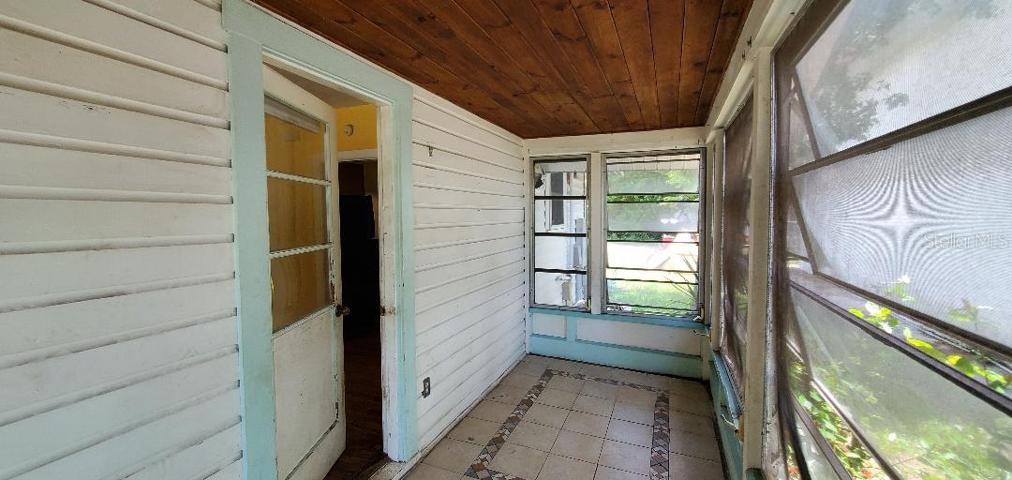 Entry front porch, tiled floor, living room on left