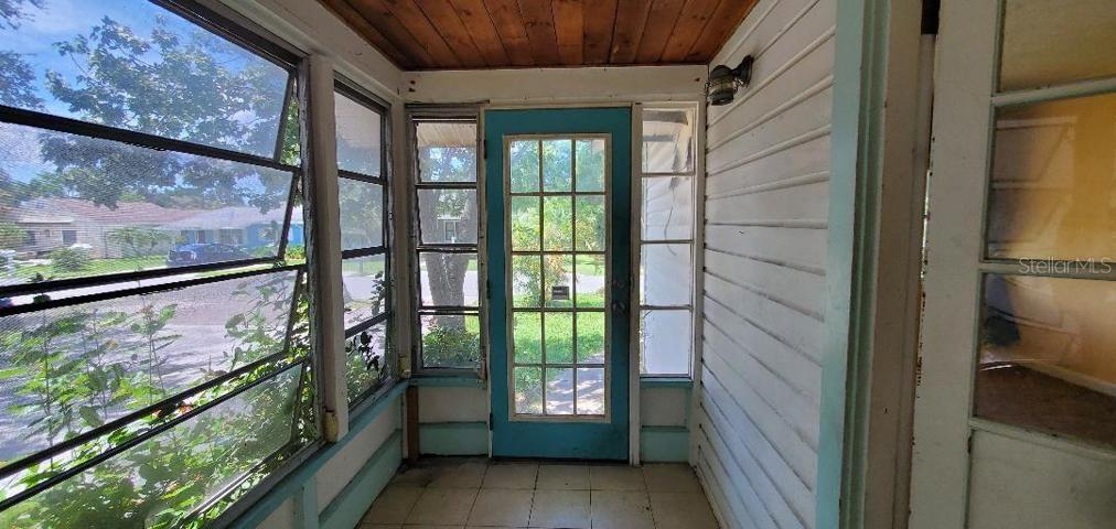 Foyer inside front door, living room entry on right