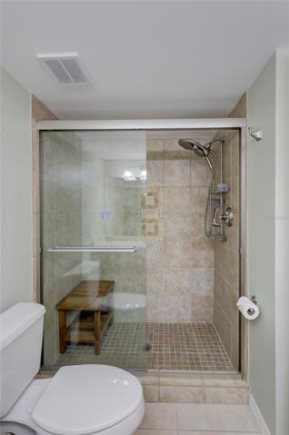 The Guest bath has a large tiled shower with beautiful sliding doors.