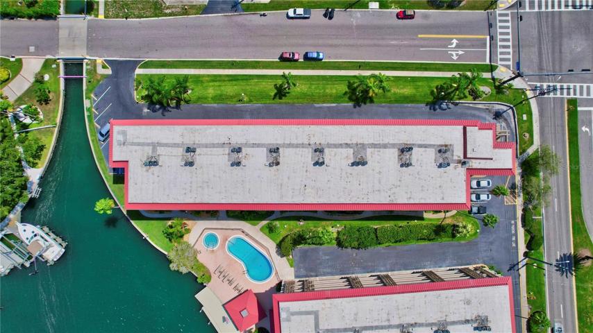 See the building from up high, like a bird's-eye view. It's like looking down at a cool structure surrounded by the area