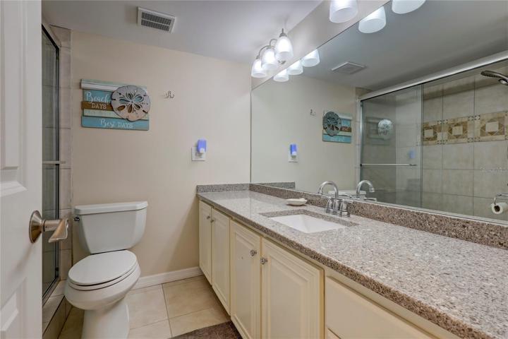 The ensuite bathroom is large and has a large tiled shower with sliding doors.