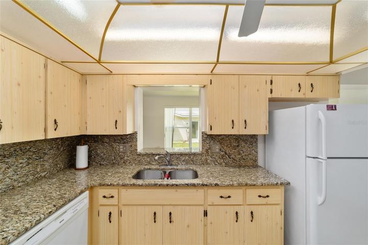 Kitchen has a pass through to back living area too