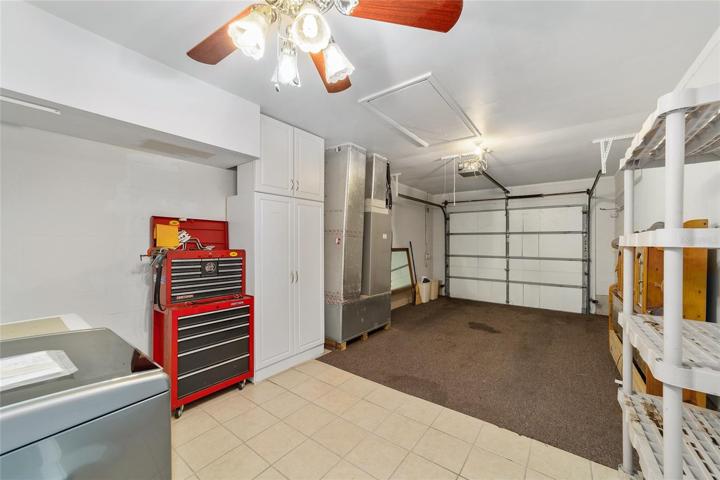 Carpeted garage with screen door
