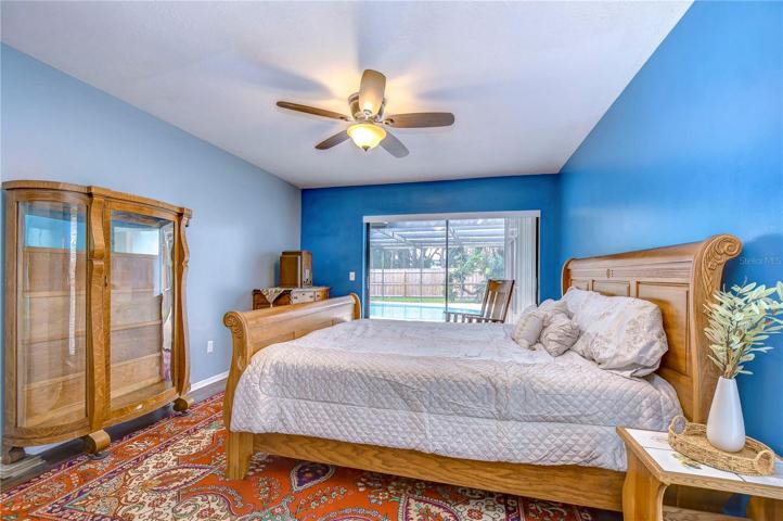 Primary bedroom with sliders to pool