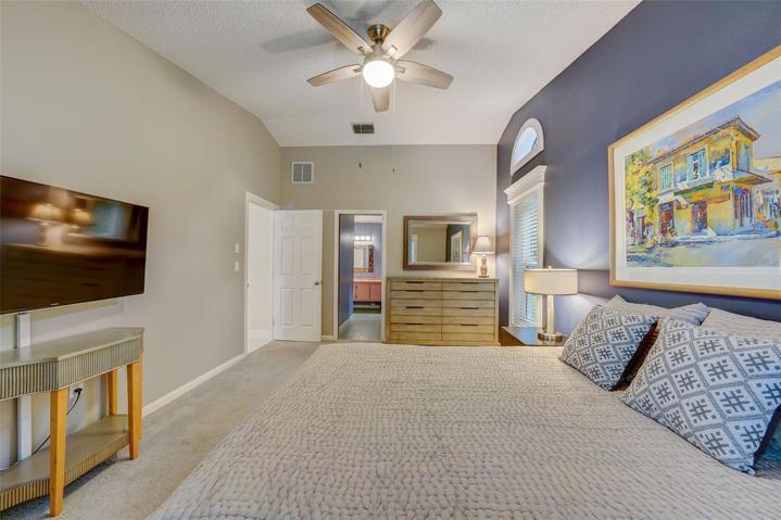 The primary bedroom offers vaulted ceilings, walk-in closet, an enviable lake view, and an en-suitebathroom