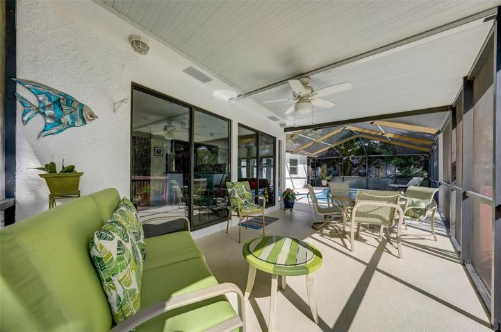 Enjoy entertaining your guests around the screened-in pool & covered patio area. Two sets of glass sliders from the sunroom.