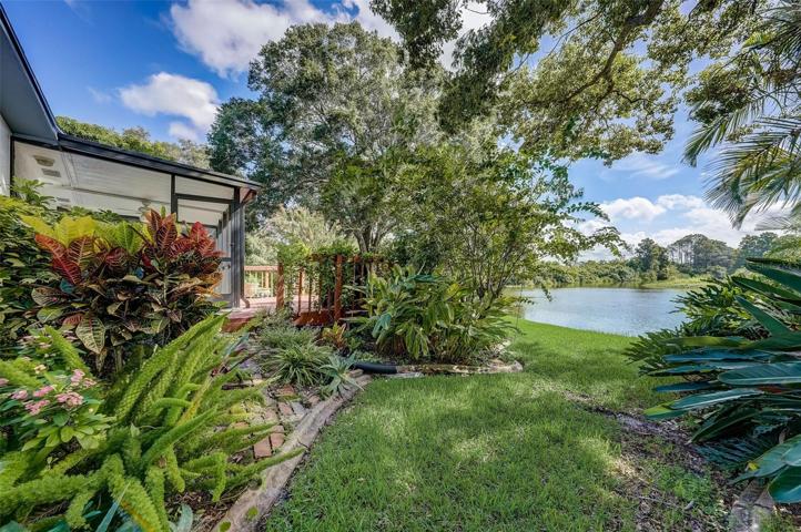 The well-manicured mature landscaping adds to the curb appeal and creates a serene tropical sanctuary in the back yard