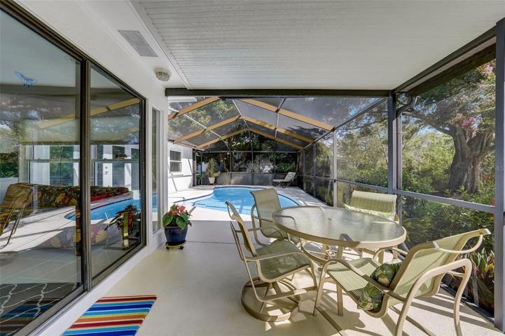 Enjoy entertaining your guests around the screened-in pool & covered patio area.