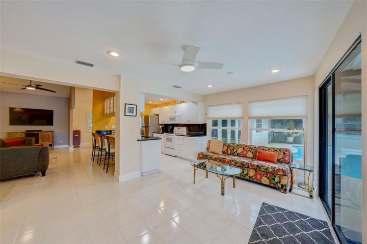 Beautiful ceramic tile flows seamlessly into the sunroom from the kitchen and family room.