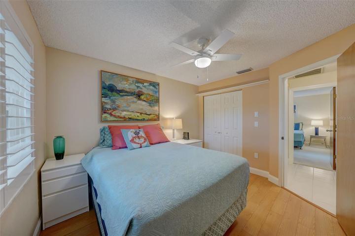 The third bedroom has a lake view, laminate flooring, and plantation shutters.