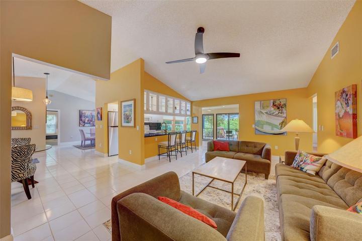Family room with breakfast bar and views of lake and covered outdoor eating/sitting area