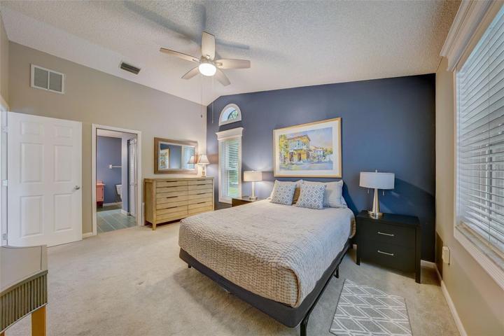 The primary bedroom offers vaulted ceilings, walk-in closet, an enviable lake view, and an en-suitebathroom