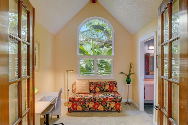 The second bedroom is complete with Frenchdoors, vaulted ceiling, large arched window overlooking the front yard, and would function well as a nursery or office