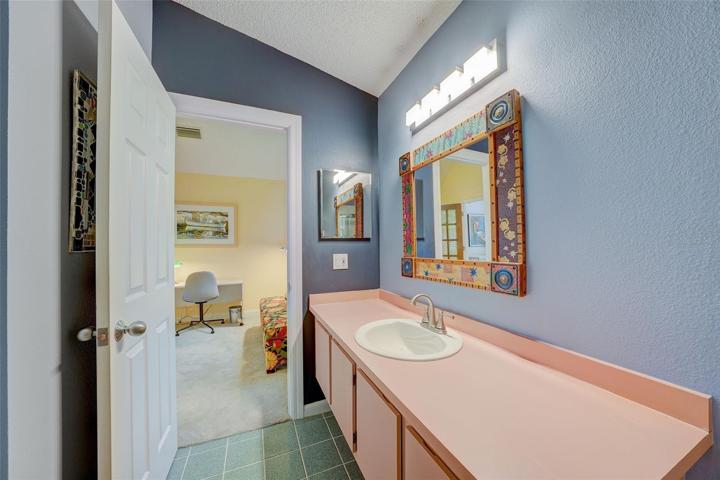 The bathroom offers a combination tub/shower and opens to the second bedroom.
