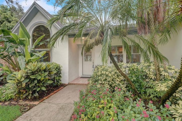 The well-manicured mature landscaping adds to the curb appeal